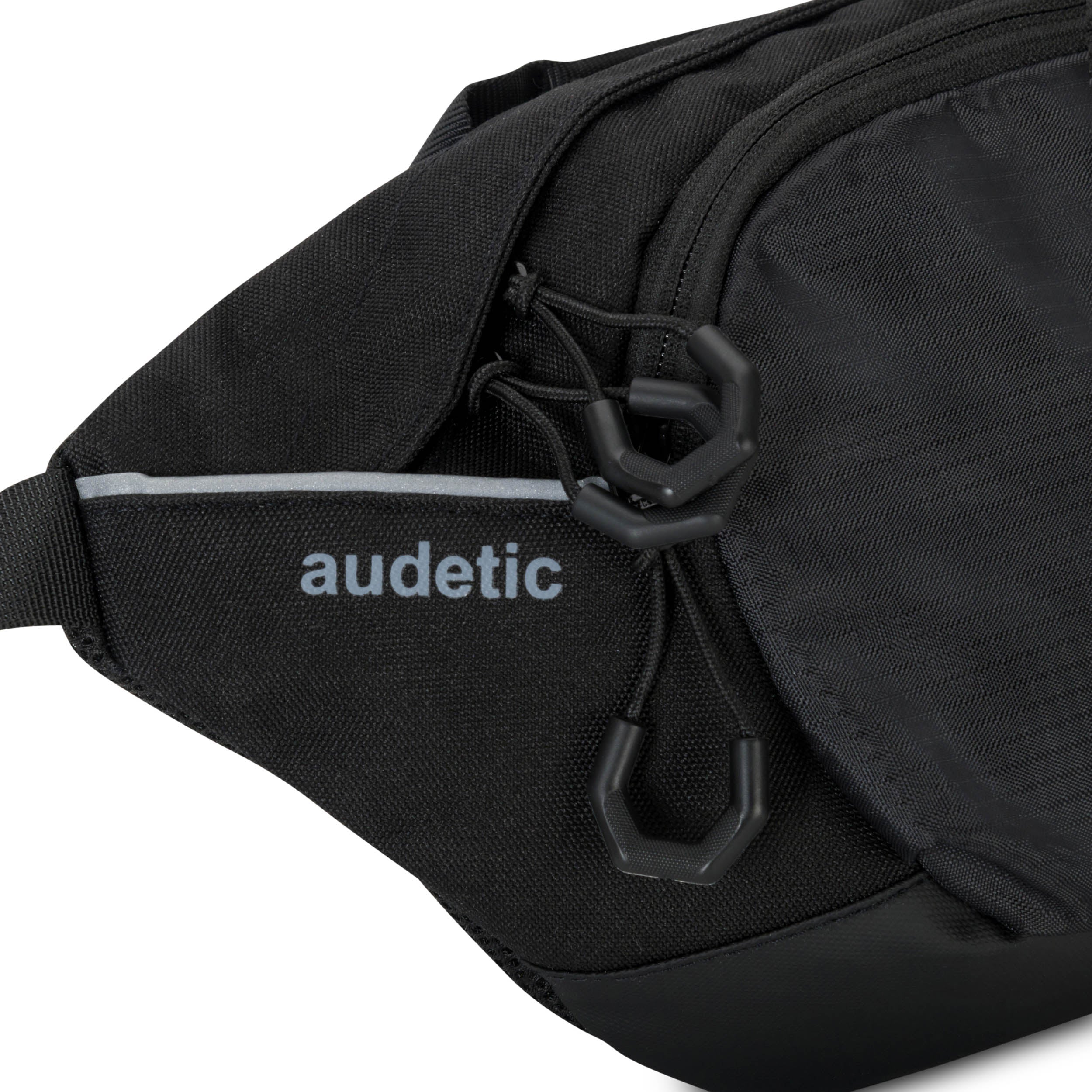 Schwarze Bauchtasche DRIP von audetic mit grauem Logo und Reißverschlussanhängern