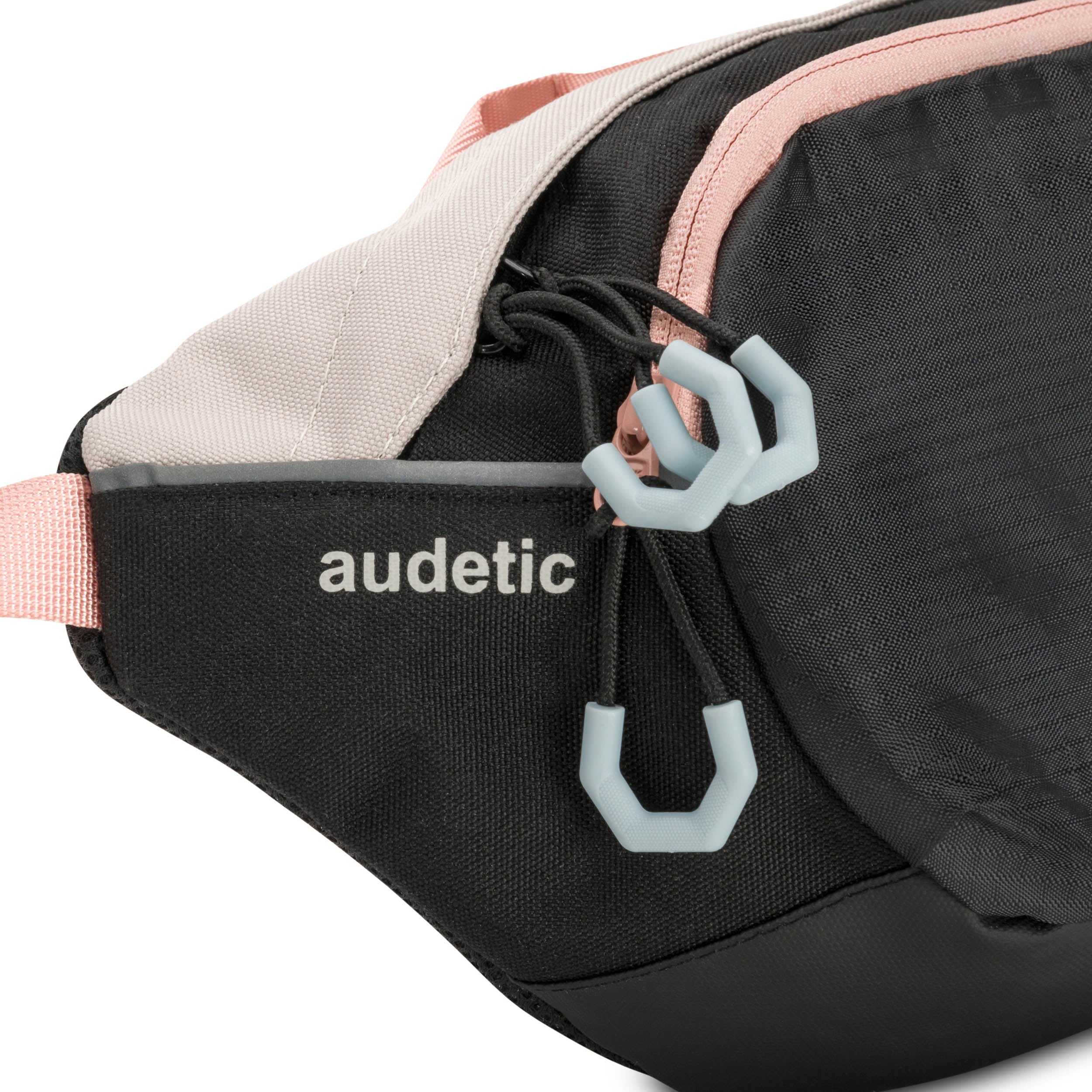 Audetic Bauchtasche DRIP in Schwarz mit rosa Details und grauen Reißverschlussanhängern
