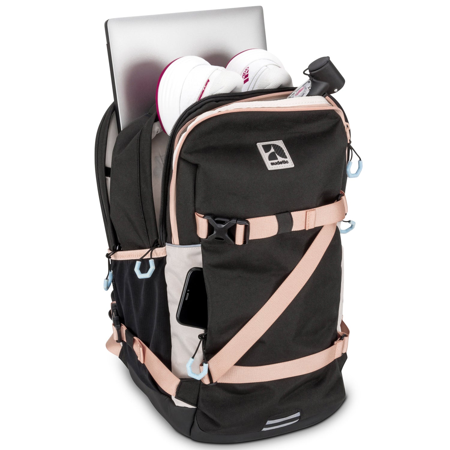 Schulrucksack COSMO schwarz mit rosa Akzenten, gefüllt mit Laptop, weißen Sportschuhen und Wasserflasche